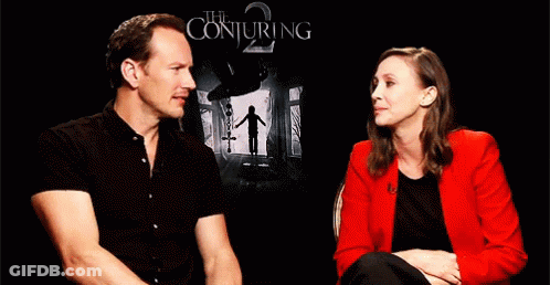 A Man And A Woman Are Sitting Next To Each Other And Laughing . GIF