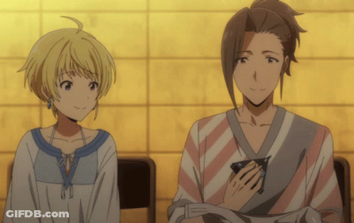 A Man And A Woman Are Sitting Next To Each Other And Smiling GIF