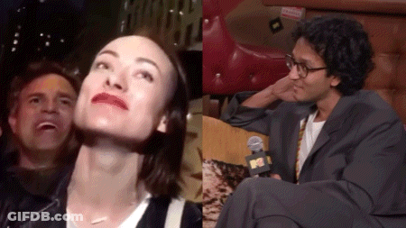 A Man And A Woman Are Sitting Next To Each Other And The Man Is Wearing Glasses GIF