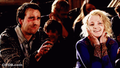 A Man And A Woman Are Sitting Next To Each Other And The Woman Is Smiling GIF
