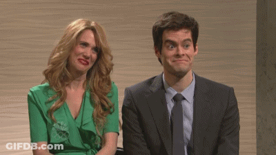 A Man And A Woman Are Sitting Next To Each Other And The Woman Is Wearing A Green Dress . GIF