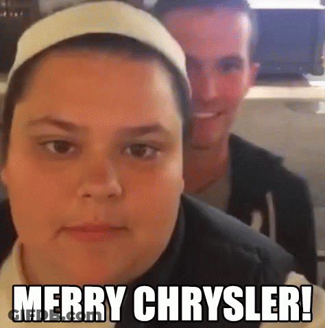 A Man And A Woman Are Sitting Next To Each Other And The Woman Is Wearing A Headband And The Man Is Smiling . GIF