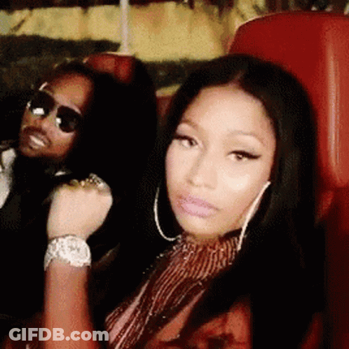 A Man And A Woman Are Sitting Next To Each Other In A Car . GIF