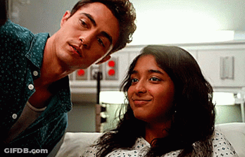 A Man And A Woman Are Sitting Next To Each Other In A Hospital Room . GIF