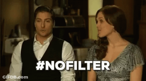 A Man And A Woman Are Sitting Next To Each Other In A Room And The Woman Is Talking To The Man . GIF