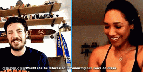 A Man And A Woman Are Sitting Next To Each Other In A Room . GIF