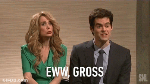 A Man And A Woman Are Sitting Next To Each Other On A Stage . The Woman Is Wearing A Green Dress . GIF