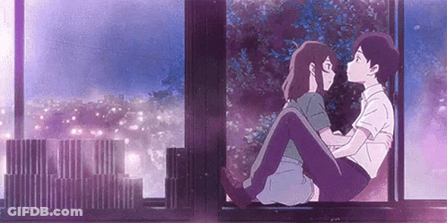 A Man And A Woman Are Sitting Next To Each Other On A Window Sill And Kissing . GIF