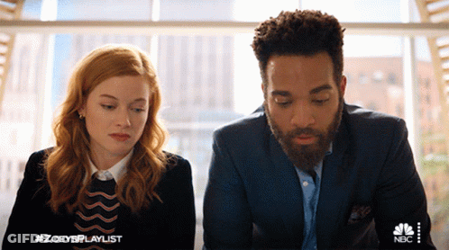 A Man And A Woman Are Sitting Next To Each Other With A Nbc Logo In The Corner GIF