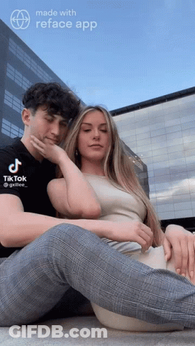 A Man And A Woman Are Sitting Next To Each Other With A Tik Tok App On The Bottom GIF
