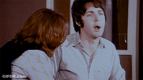 A Man And A Woman Are Sitting Next To Each Other With The Man Making A Funny Face GIF