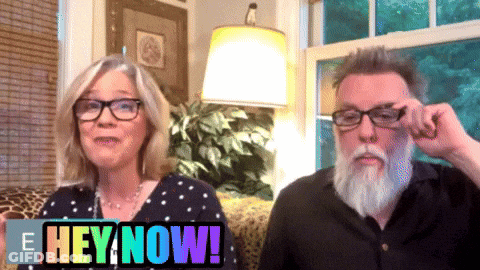A Man And A Woman Are Sitting Next To Each Other With The Words Hey Now Behind Them GIF