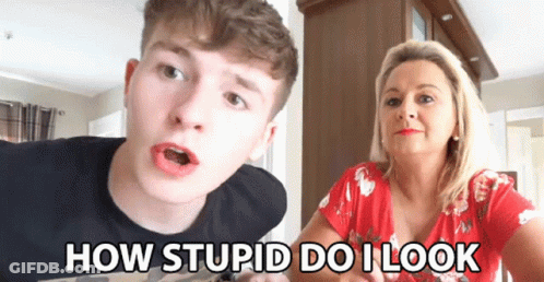 A Man And A Woman Are Sitting Next To Each Other With The Words How Stupid Do I Look On The Screen GIF