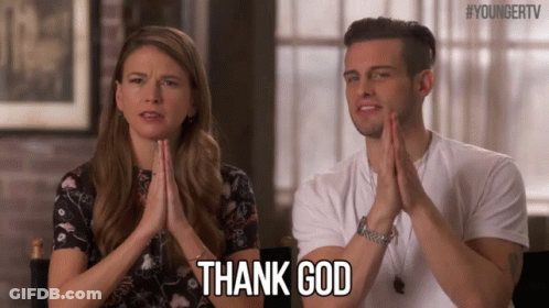 A Man And A Woman Are Sitting Next To Each Other With Their Hands Folded And The Man Is Saying Thank God GIF