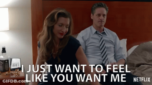 A Man And A Woman Are Sitting On A Bed And The Man Says " I Just Want To Feel Like You Want Me Netflix " GIF