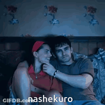 A Man And A Woman Are Sitting On A Bed And The Word Nashekuro Is On The Bottom Right GIF