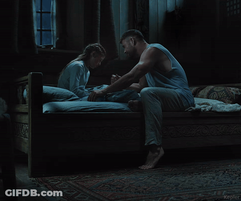 A Man And A Woman Are Sitting On A Bed In A Dark Room With The Word Kepler In The Corner GIF