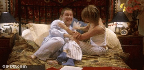 A Man And A Woman Are Sitting On A Bed With The Words Notmydate Written On The Bottom GIF
