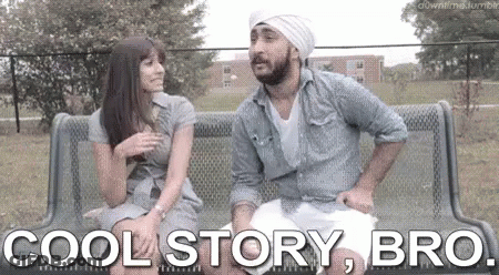 A Man And A Woman Are Sitting On A Bench In A Park . GIF