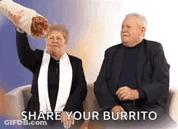 A Man And A Woman Are Sitting On A Couch And The Woman Is Holding A Large Burrito . GIF