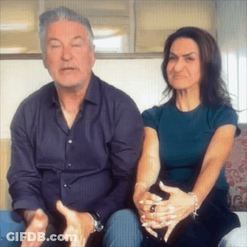 Man And Woman Sitting On Couch Woman Making Face GIF