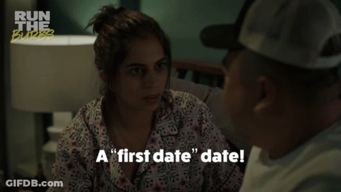 A Man And A Woman Are Sitting On A Couch And The Woman Is Saying " A First Date Date " GIF
