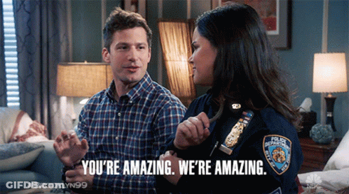 A Man And A Woman Are Sitting On A Couch And The Woman Is Wearing A Badge That Says New York Police Department GIF