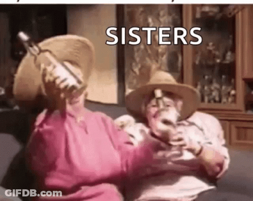 A Man And A Woman Are Sitting On A Couch Holding Wine Bottles . GIF