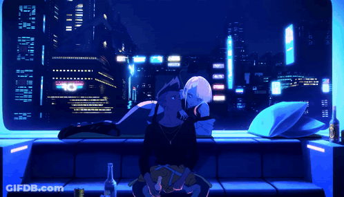 A Man And A Woman Are Sitting On A Couch In Front Of A Window With A Sign That Says 10 On It GIF