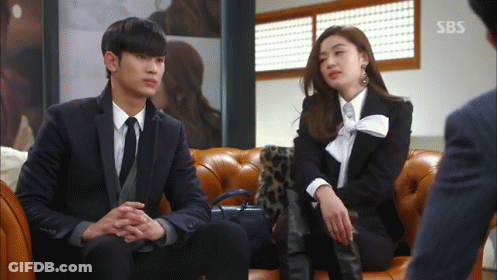 A Man And A Woman Are Sitting On A Couch With Sbs Written On The Bottom GIF