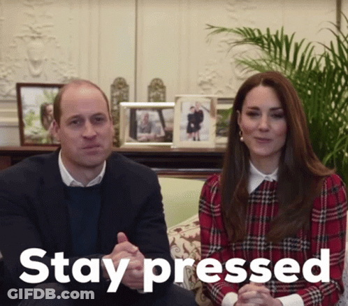A Man And A Woman Are Sitting On A Couch With The Word Stay Pressed Behind Them GIF