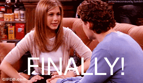 A Man And A Woman Are Sitting On A Couch With The Words Finally Written On The Bottom GIF