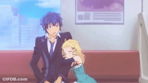 A Man And A Woman Are Sitting On A Couch . GIF