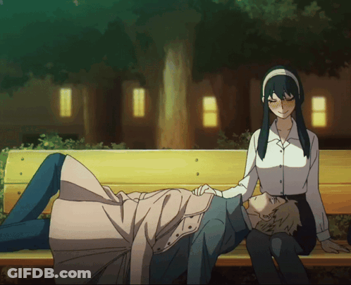 A Man And A Woman Are Sitting On A Park Bench GIF