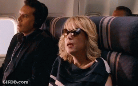 A Man And A Woman Are Sitting On A Plane . GIF