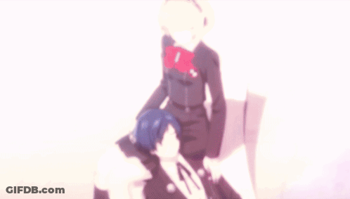 A Man And A Woman Are Sitting On A White Chair GIF