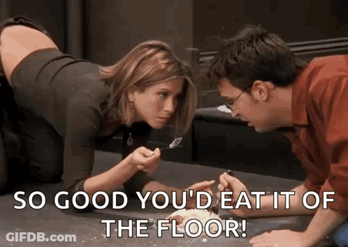 A Man And A Woman Are Sitting On The Floor Eating Food With A Fork . GIF