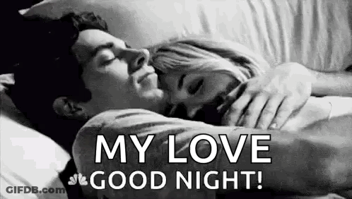 A Man And A Woman Are Sleeping In A Bed . GIF