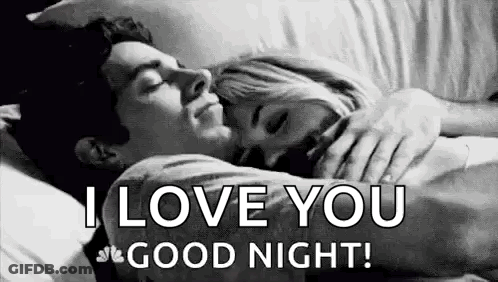 A Man And A Woman Are Sleeping In A Bed . GIF