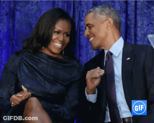A Man And A Woman Are Smiling And Looking At Each Other In Front Of A Gif Logo GIF