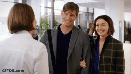 Smiling Man And Woman Talking To Woman In White GIF