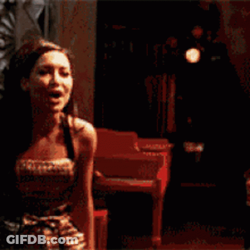 A Man And A Woman Are Smiling At Each Other GIF
