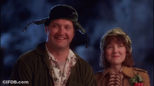 A Man And A Woman Are Smiling For The Camera GIF