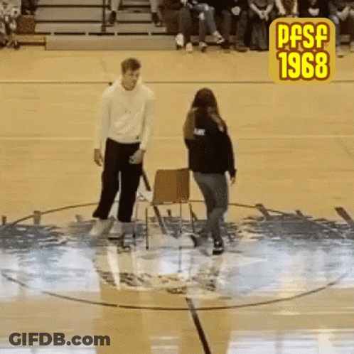 A Man And A Woman Are Standing In A Circle On A Basketball Court With The Year 1968 On The Bottom GIF