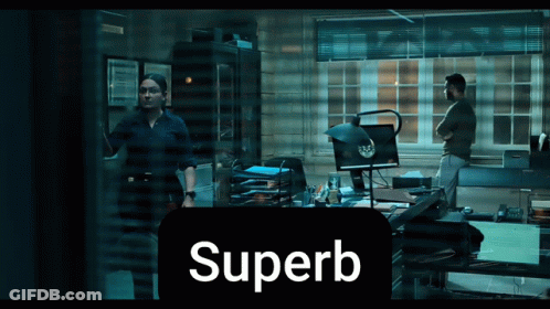 A Man And A Woman Are Standing In A Dark Room With The Word Superb In The Corner GIF