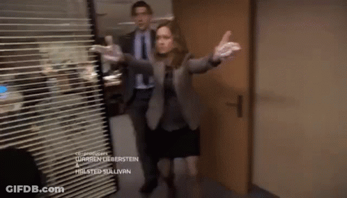 A Man And A Woman Are Standing In A Hallway With The Name Warren Lieberstein On The Bottom Of The Screen GIF