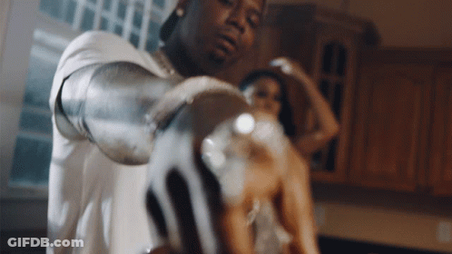 A Man And A Woman Are Standing In A Kitchen GIF