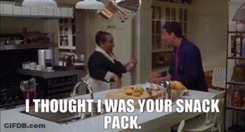 A Man And A Woman Are Standing In A Kitchen With The Words I Thought I Was Your Snack Pack . GIF