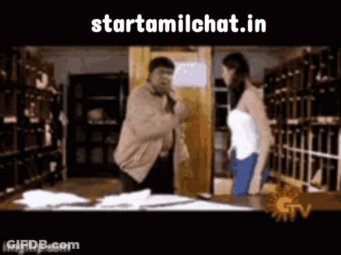 A Man And A Woman Are Standing In A Library And The Website Starttamilchat.in Is Visible GIF