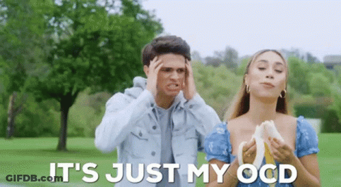 A Man And A Woman Are Standing In A Park And The Woman Is Holding A Banana . GIF